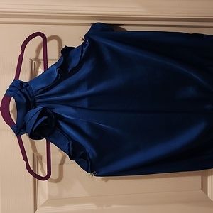 Dressy Satin Top with a flower and ruffle accents.